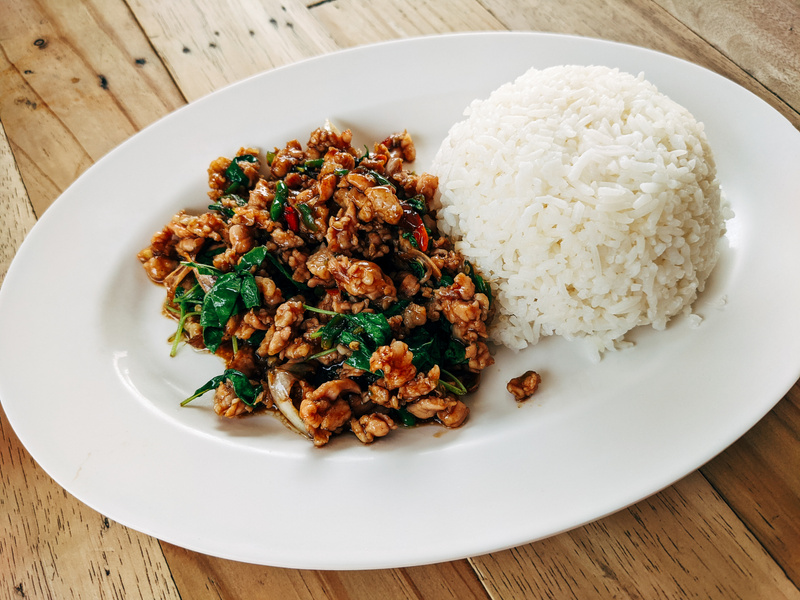 Stir Fried Thai Basil with Minced Pork and Rice on Oval Ceramic Plate